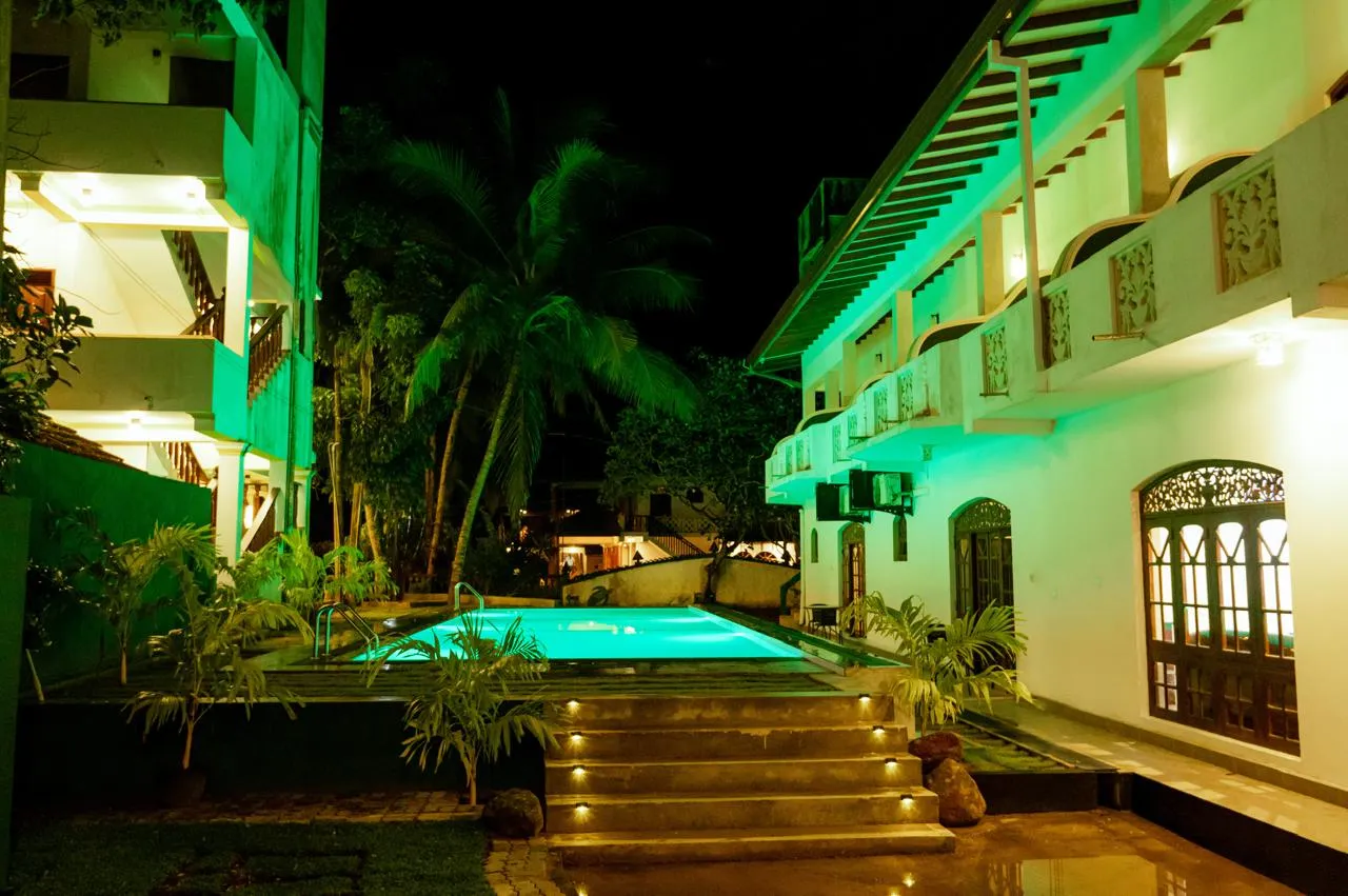 Lighted courtyard steps leading to the swimming pool at night